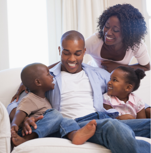 Happy family at home on the couch